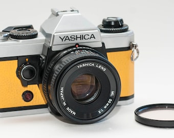 YASHICA FX-D Quartz  with 50 mm f2 lens. Silver with yellow skin.