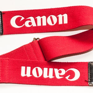 Canon camera strap with EOS logo. Red