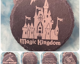 May include: Set of six slate coasters featuring different Disney attractions. The coasters are round and have a dark gray color. The images on the coasters include Space Mountain, Magic Kingdom, Big Thunder Mountain Railroad, Tiana's Bayou Adventure, and a quote about leaving today and entering the world of yesterday, tomorrow, and fantasy.