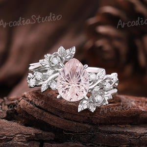 May include: A set of three ceramic mugs with a speckled, matte finish. The mugs are in shades of cream, light brown, and dark brown. Each mug has a simple, minimalist design and a rounded handle.