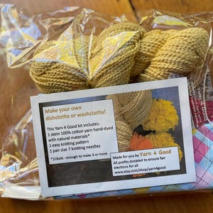 May include: A craft kit for making dishcloths or washcloths. The kit includes a skein of yellow cotton yarn, a knitting pattern, and size 7 knitting needles. The packaging includes the text "Make your own dishcloths or washcloths!"