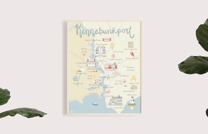 May include: A hand-drawn illustrated map of Kennebunkport, Maine, with a light blue background and a beige border. The map features various landmarks and businesses, including The Clam Shack, The Inn at Ocean's Edge, and The Nonantum Resort. The map is framed in a light wood frame.