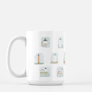 May include: White ceramic mug with a colorful illustration of lighthouses on a light blue background. The mug has a large handle and is perfect for enjoying a hot beverage.