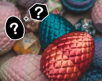May include: A close-up of a collection of dragon eggs, some are metallic red, teal, and purple. There are also several dice in the image.