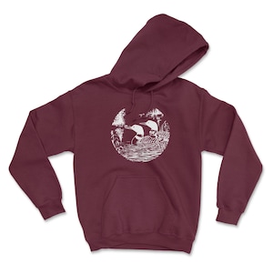 May include: A maroon hoodie with a white graphic of two loons in a circle on the front. The loons are facing each other and appear to be swimming in a lake.
