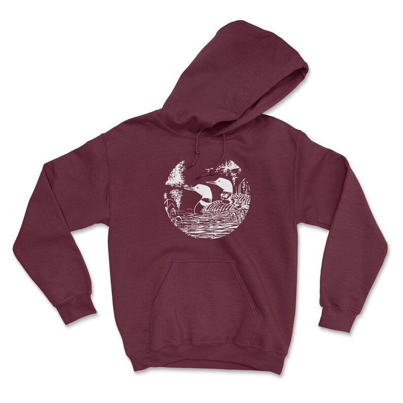 May include: A maroon hoodie with a white graphic of two loons in a circle on the front. The loons are facing each other and appear to be swimming in a lake.