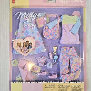 May include: A packaged doll set with the text "Midge & baby" and "happy family". The set includes a doll dress, purse, baby clothes, shoes, and accessories. The packaging is pink, yellow, and purple.