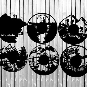 May include: Six black and white silhouette designs of different outdoor activities. The designs include a mountain scene, a lake scene, a forest scene, a snowboarding scene, a camping scene, and a mountain climbing scene. The designs are all circular and have a white background.