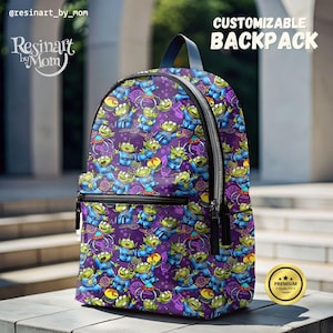 May include: Purple backpack with a repeating pattern of green alien characters from the Toy Story movie franchise. The backpack has black zippers and a black handle. The text "CUSTOMIZABLE BACKPACK" is in white letters on a black background at the top of the image. A gold star with the text "PREMIUM QUALITY" is in the lower right corner of the image.