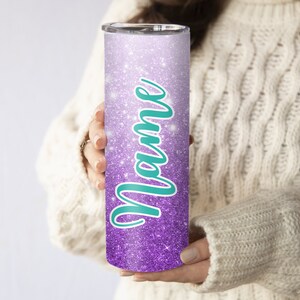 May include: A purple and white glitter tumbler with the word "Mom" written in teal.