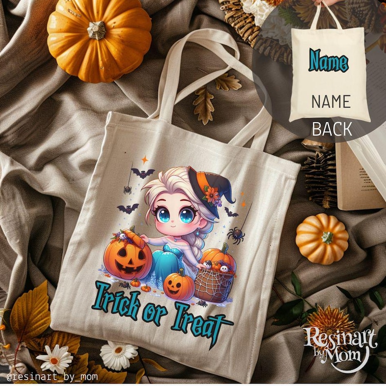 May include: Beige canvas tote bag with a Halloween design. It features a cartoon princess, pumpkins, bats, and the text "Trick or Treat". The back of the bag has the word "Name" printed on it.