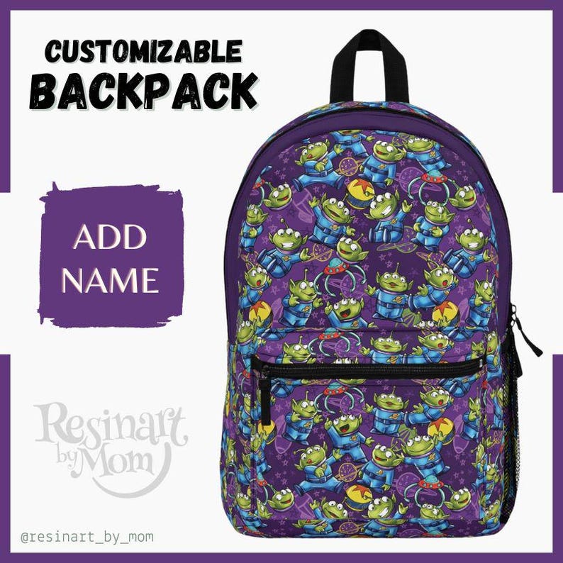 May include: Purple backpack with a repeating pattern of green alien characters from the movie Toy Story. The backpack has a black zipper and a black handle. The text "ADD NAME" is on a purple background.