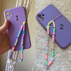 May include: Two purple phone cases with colorful beaded phone straps. The first strap has the word "SEVDA" spelled out in white beads. The second strap has the words "BABY GIRL" spelled out in white beads.