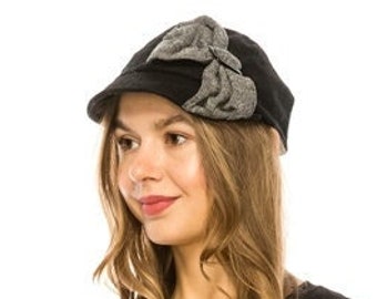 Wool blend cabbie hat with big slanted bow in tweed fabric.