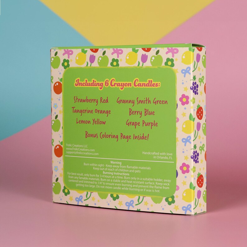 May include: A green box with a colorful pattern of lemons, strawberries, and apples. The box includes 6 crayon candles in the following scents: Strawberry Red, Granny Smith Green, Tangerine Orange, Lemon Yellow, Berry Blue, and Grape Purple. The box also includes a bonus coloring page inside. The box is handcrafted with love in Orlando, FL.