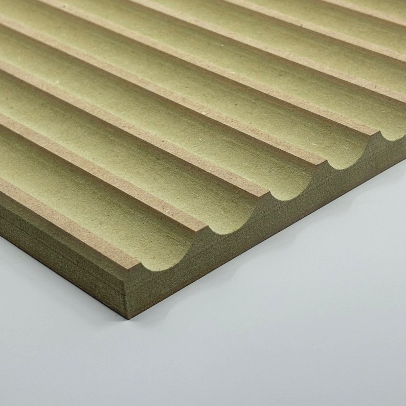 May include: A close-up of a light green acoustic panel with a wavy, textured surface. The panel is made of wood and has a natural, organic look.