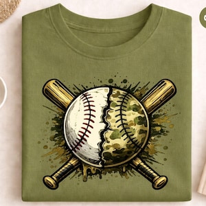 May include: Olive green sweatshirt featuring a baseball design. The baseball is split, with one half traditional and the other camouflage. Two crossed baseball bats are behind the ball. The design has a watercolor effect.