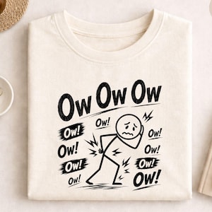 May include: A natural-colored sweatshirt with the words "Ow Ow Ow" in bold black letters. A stick figure with a pained expression clutches their back, surrounded by "Ow!" exclamations, suggesting back pain. The word "NATURAL" is in a circle.