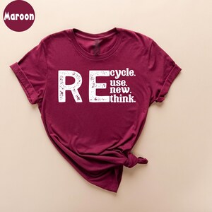 May include: A maroon t-shirt with a white graphic that says "REcycle. use. new. think."