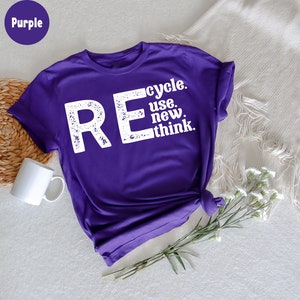 May include: Purple t-shirt with the text "REcycle. use. new. think." in white distressed lettering.