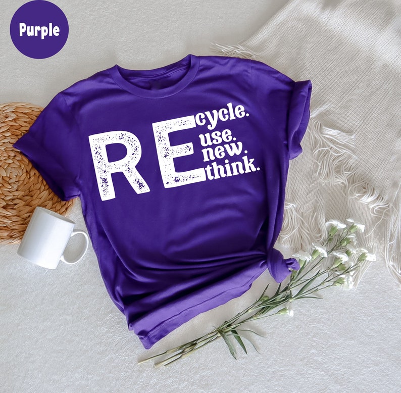 May include: Purple t-shirt with the text "REcycle. use. new. think." in white distressed lettering.