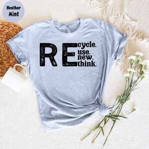 May include: Heather mint grey t-shirt with a black graphic that says "REcycle. use. new. think."