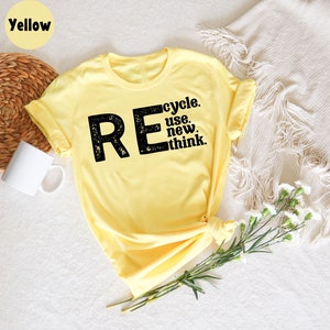 May include: Yellow t-shirt with a black graphic that says "REcycle. use. new. think."