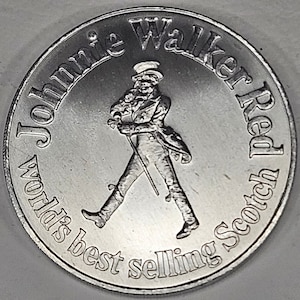 May include: Silver coin featuring a walking man with a cane and the text "Johnnie Walker Red" and "World's best selling Scotch".