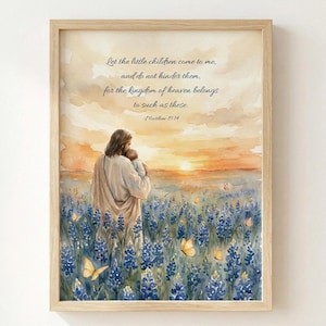 May include: Framed watercolour print showing a figure holding a child in a field of blue flowers with butterflies. The text reads "Let the little children come to me..." and "Matthew 19:14". The background features a sunset. The frame is light wood.