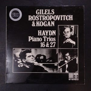 May include: A black and white vinyl record cover featuring the text GILELS ROSTROPOVITCH & KOGAN HAYDN Piano Trios 16 & 27. The cover includes three black and white photographs of musicians and a circular Limited Edition Collector's Series logo.