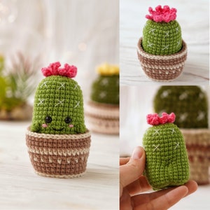 May include: A green crocheted cactus with a pink flower on top, sitting in a brown crocheted pot. The cactus has a smiling face and is a cute handmade decoration.