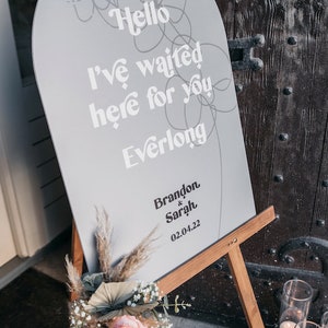 Modern boho wedding invitation suite. Featuring elegant curved shapes and a subtle floral design, this collection can be adapted to your colours. Arch shape welcome sign featuring song lyrics and couples names and wedding date.