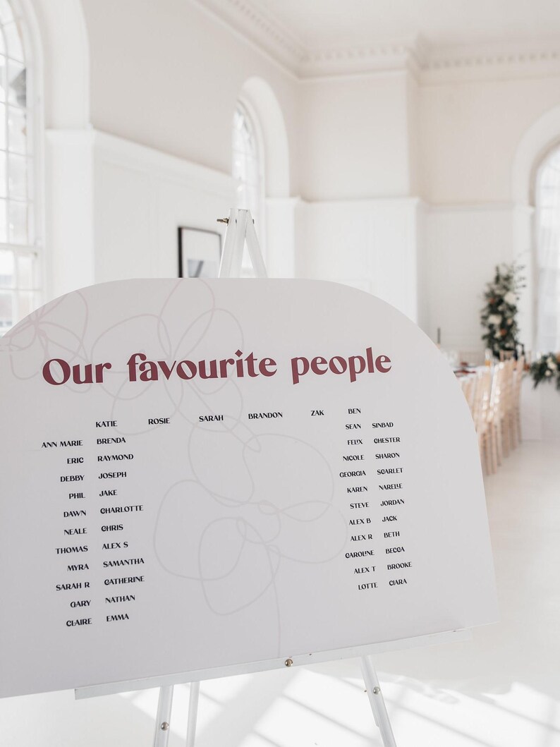 Modern boho wedding invitation suite. Featuring elegant curved shapes and a subtle floral design, this collection can be adapted to your colours.
Arch shape seating chart situated at a wedding breakfast.