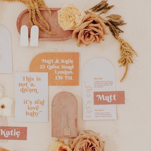 Modern boho wedding invitation suite. Featuring elegant curved shapes and a subtle floral design, this collection can be adapted to your colours. Includes a save the date, invitation, information card and rsvp. On the day stationery also available.