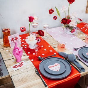 The ultimate red and pink wedding stationery! Featuring a bursting heart design, retro font and fun wording, this is the Malibu collection. On the day stationery including heart shape place cards, menus, table numbers, welcome signs and table plans.