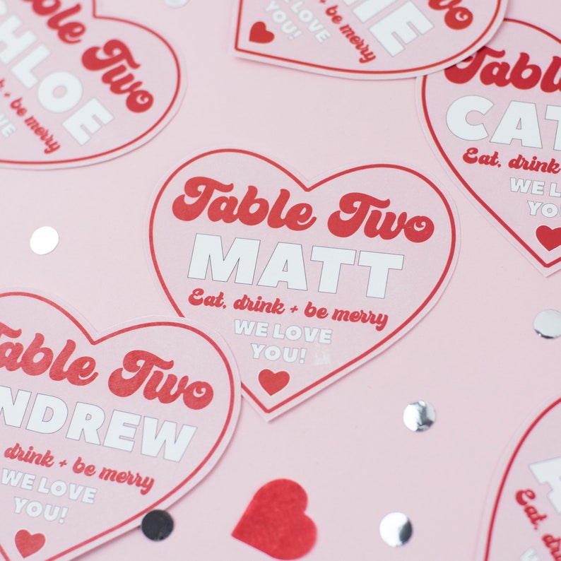 The ultimate red and pink wedding stationery! Featuring a bursting heart design, retro font and fun wording, this is the Malibu collection. On the day stationery including heart shape place cards, menus, table numbers, welcome signs and table plans.