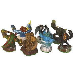 May include: A selection of brightly coloured action figures, each representing a different creature or character. The figures have diverse designs, including wings, spikes, and other unique features. They are placed on small, textured bases.