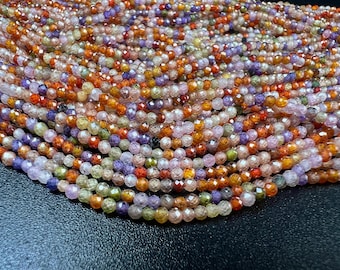 May include: Close-up of a collection of faceted gemstone beads in various colors, including orange, purple, green, and pink. The beads are strung together, creating a textured and colorful display, perfect for jewelry making.