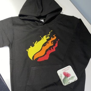 May include: Black hoodie with a yellow, orange, and red flame graphic on the front. The hoodie has a pocket on the front and a drawstring hood.