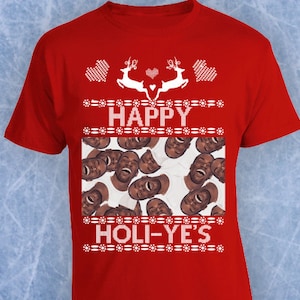 May include: Red t-shirt with a festive design. The shirt features the words "HAPPY HOLI-YE'S" in white, with reindeer and heart graphics. The shirt also has a collage of faces. The Ferda Apparel logo is in the bottom left corner.