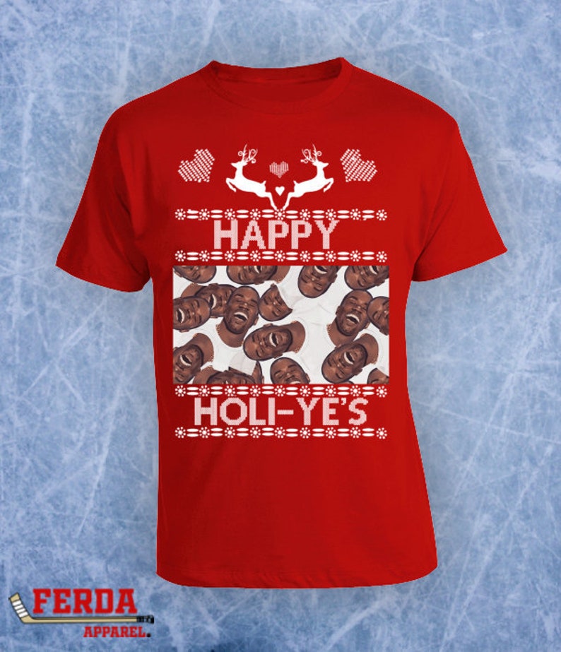 May include: Red t-shirt with a festive design. The shirt features the words "HAPPY HOLI-YE'S" in white, with reindeer and heart graphics. The shirt also has a collage of faces. The Ferda Apparel logo is in the bottom left corner.