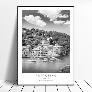May include: Black and white photograph of the Italian village of Portofino, with colorful buildings on a hillside overlooking a harbor with boats. The text "PORTOFINO ITALY 44.3032&deg; N, 9.2098&deg; E" is at the bottom of the image.