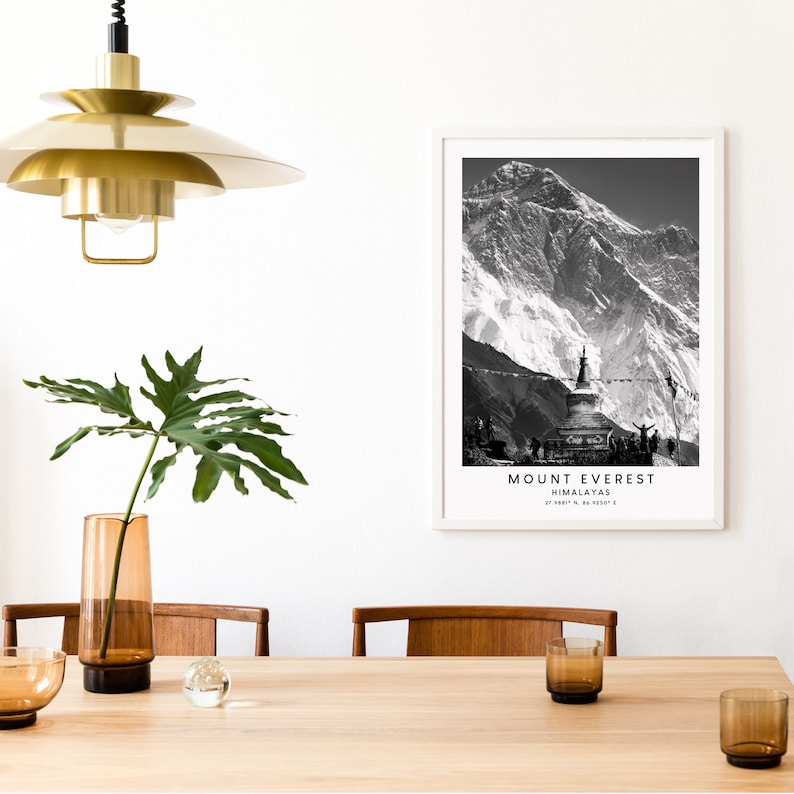 May include: Black and white photograph of Mount Everest, the highest mountain in the world, with a prayer flag and a stupa in the foreground. The text "MOUNT EVEREST HIMALAYAS 29,031.7 ft. 8,848.86 m" is printed below the image.