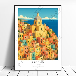 May include: A framed art print of Procida, Italy, featuring colorful buildings cascading down a hillside towards the sea. The artwork showcases a church with a domed roof and the text "Procida Italy". The print is set against a blue sky.