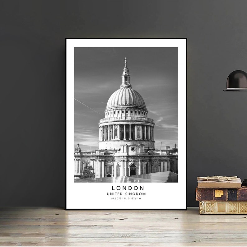 May include: Black and white photograph of St Paul's Cathedral in London, United Kingdom. The text "LONDON, UNITED KINGDOM, 51.5072&deg; N, 0.1274&deg; W" is printed below the image.