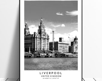 May include: Black and white photograph of the Liver Building in Liverpool, United Kingdom. The building is a historic landmark and is known for its distinctive architecture. The photo shows the building from a distance, with the River Mersey in the foreground.