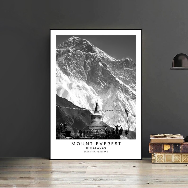 May include: A black and white photograph of Mount Everest, the highest mountain in the world, with a prayer flag and a stupa in the foreground. The text "MOUNT EVEREST HIMALAYAS 27.9881&deg; N, 86.9250&deg; E" is printed below the image.