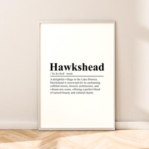 May include: Black and white printable art print with the word "Hawkshead" in a large font and a definition of the word below. The definition reads: "A delightful village in the Lake District, Hawkshead is renowned for its enchanting cobbled streets, historic architecture, and vibrant arts scene, offering a perfect blend of natural beauty and cultural charm."