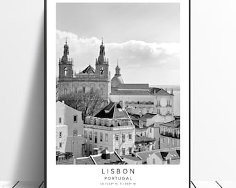 May include: Black and white photograph of the cityscape of Lisbon, Portugal. The photo features a church with two bell towers and a dome, surrounded by other buildings. The text "LISBON PORTUGAL 38.7223° N, 9.1393° W" is at the bottom of the image.
