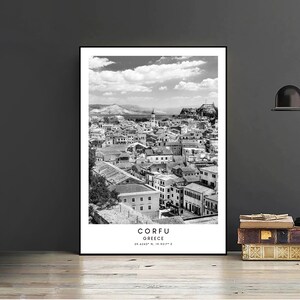 May include: A black and white photograph of the city of Corfu, Greece. The photo shows a cityscape with buildings, a harbour, and a cloudy sky. The text "CORFU GREECE 39.6243&deg; N, 19.9317&deg; E" is printed at the bottom of the photo.